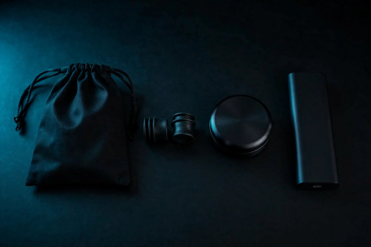 Rave Mom Kit laid out on black: drawstring pouch, ear plugs with carry case, and slim power bank